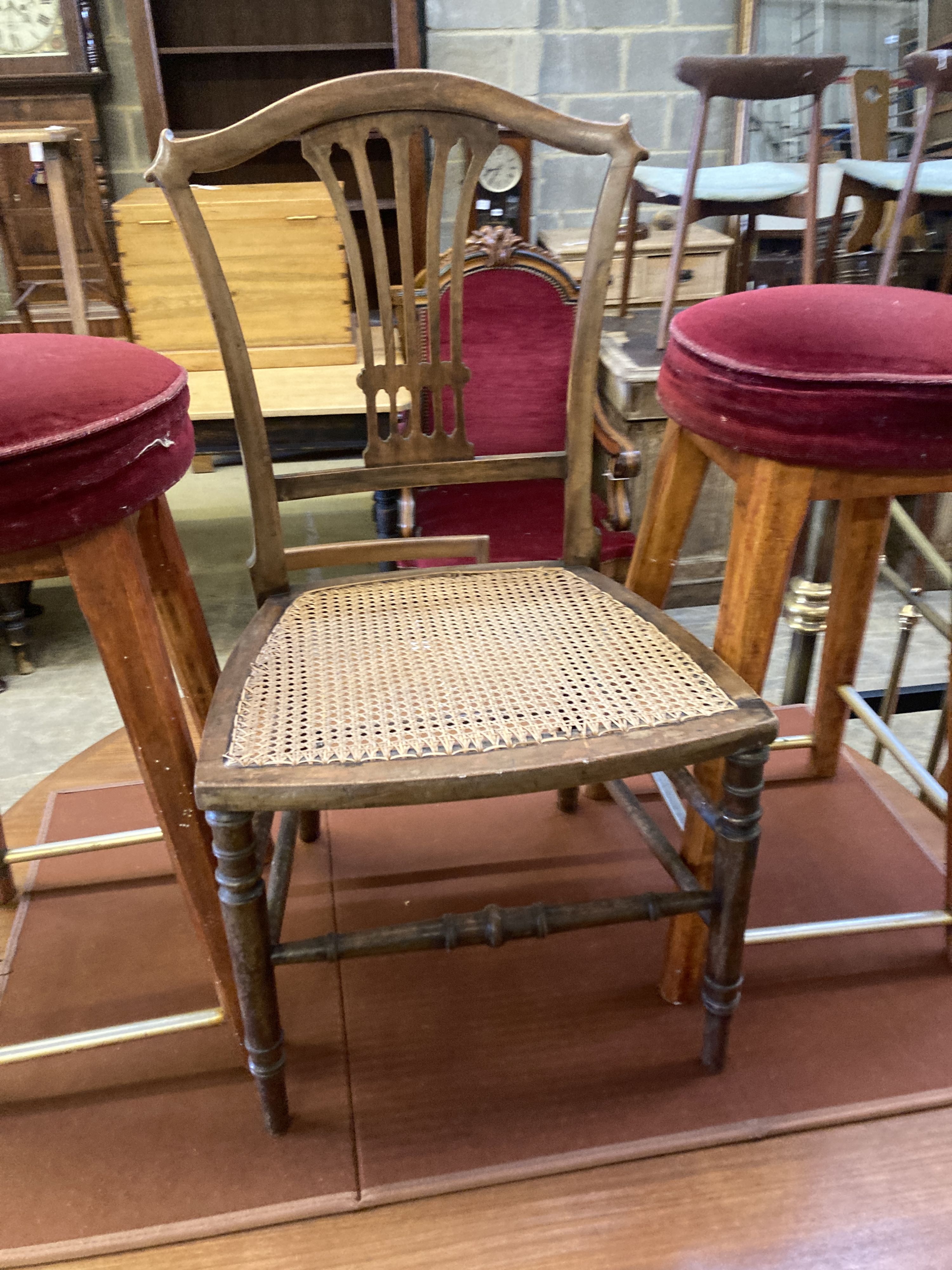 An Edwardian cane seat chair and a pair of beech stools